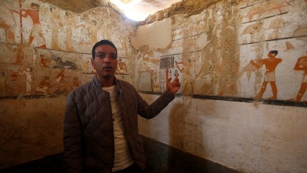 A guide from the Ministry of Antiquities inspects a discovery from Egyptâs antiquities authorities at the Giza plateau, the site of the three ancient pyramids on the outskirts of Cairo, Egypt February 3, 2018. REUTERS/Amr Abdallah Dalsh - RC111F906BF0