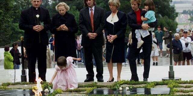 Robert F. Kennedy's granddaughter Saoirse Kennedy Hill places a white rose at the Eternal Flame, President John F. Kennedy's gravesite, at Arlington National Cemetery in Arlington, Va., June 6, 2000. Hill died Thursday at age 22. ​​​​​​(Associated Press)