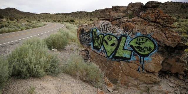 In this July 22, 2019 file photo, alien-themed graffiti adorns a rock along the Extraterrestrial Highway, near Rachel, Nev.