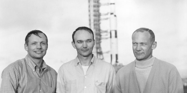 Apollo 11 astronauts Neil Armstrong, Michael Collins and Buzz Aldrin pose with their Saturn V in the background in this NASA handout photo dated May 20, 1969. REUTERS/NASA/Handout