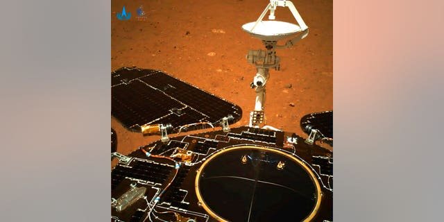 In this photo taken by China's Zhurong Mars rover and made available by the China National Space Administration (CNSA) on Wednesday, May 19, 2021, the rover's solar panels and antenna are deployed as the rover sits on its lander on the surface of Mars. (CNSA via AP)